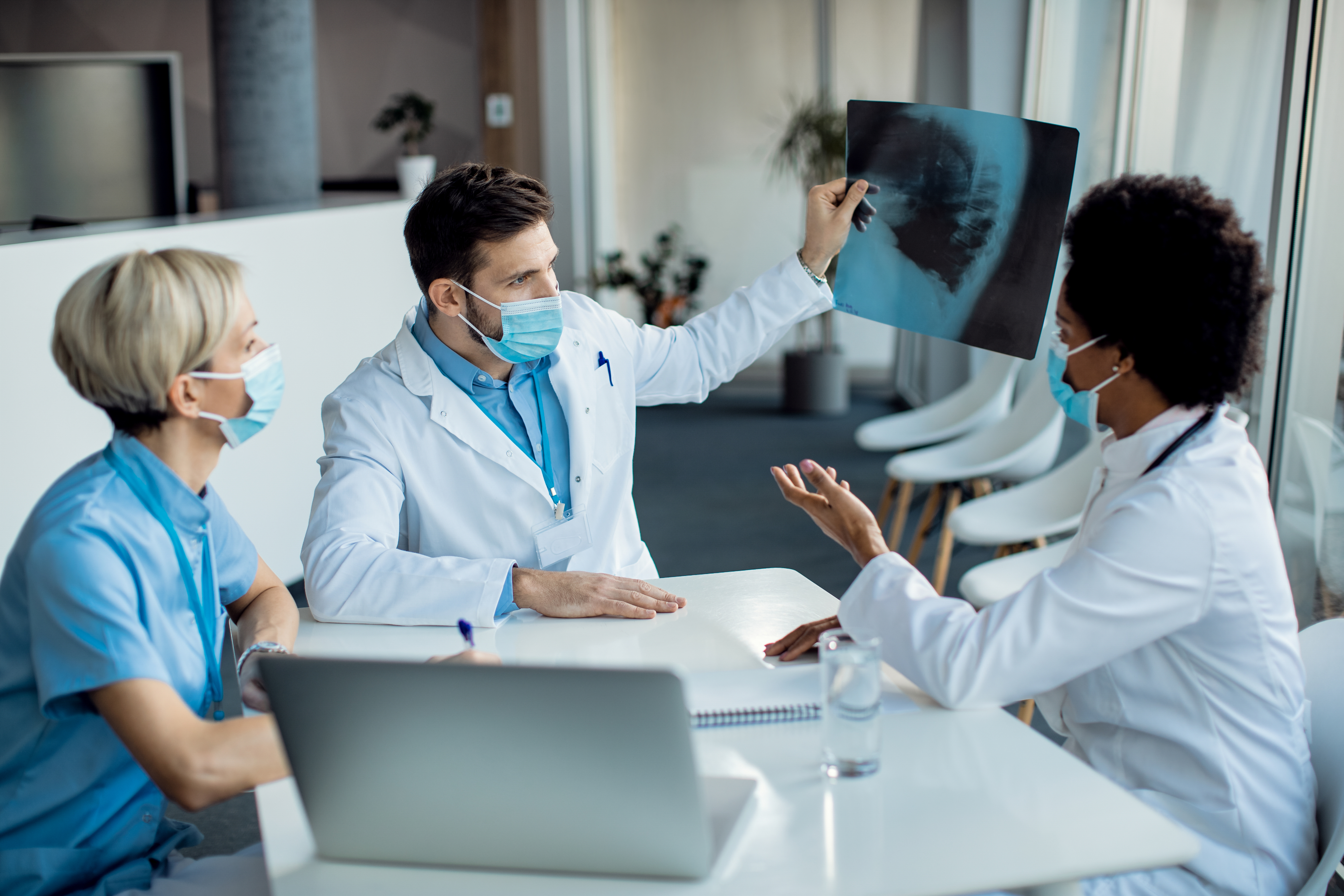 Home team of healthcare experts examining x ray image at medical clin